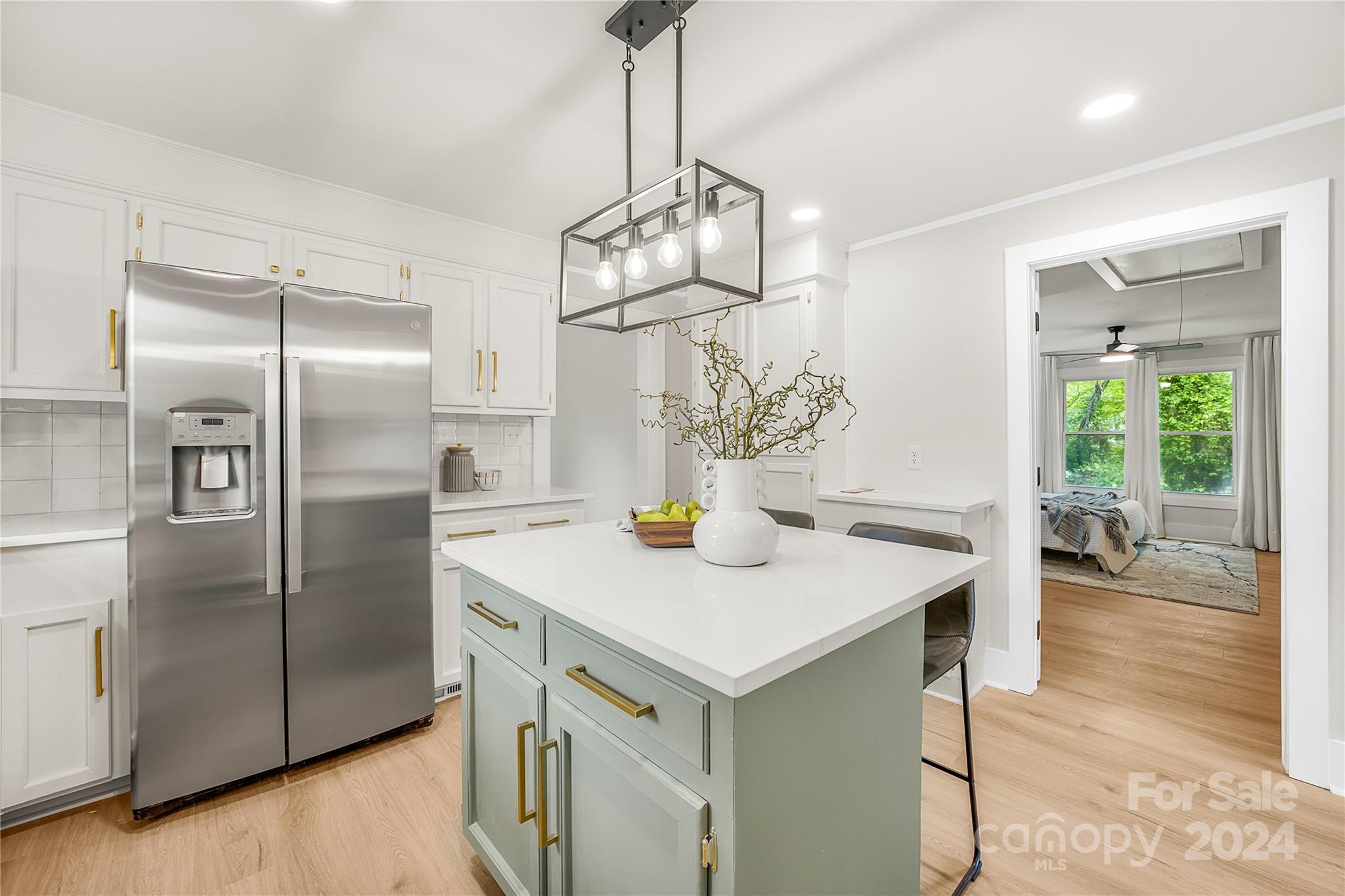 311 Roy Eaker Road Cherryville, NC 28021 - Photo 10 of 23 a kitchen with stainless steel appliances granite countertop a sink a refrigerator and a wooden floors