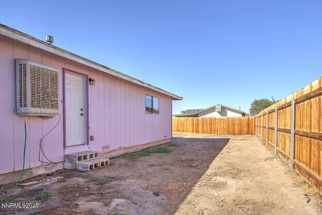 a view of a house with wooden fence