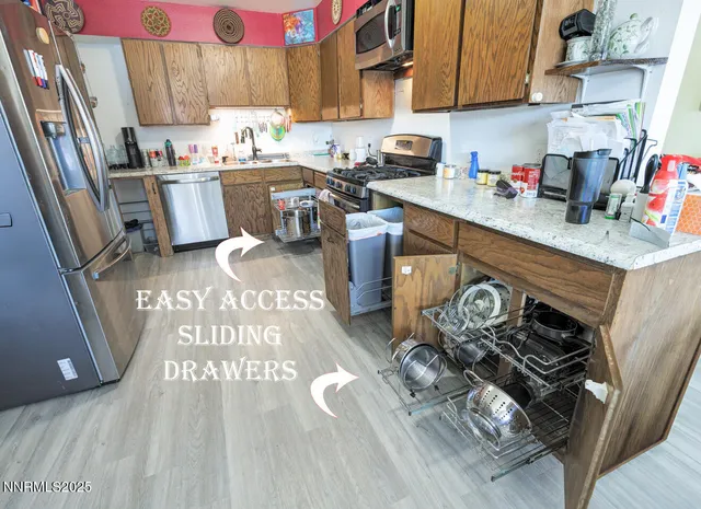 a kitchen with a sink appliances and cabinets