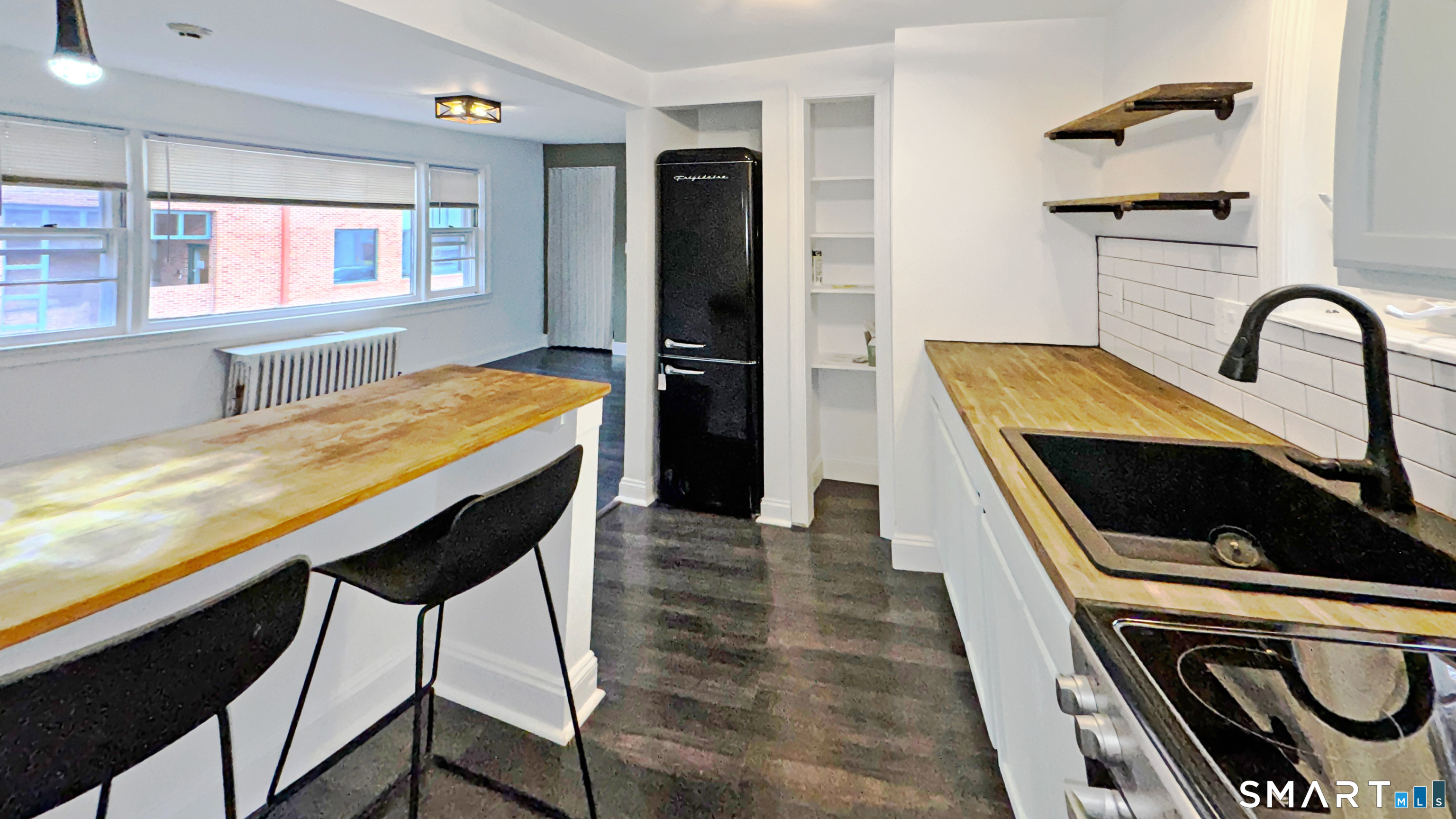 18 Riverside Avenue Westport, CT 06880 - Photo 1 of 6 a kitchen with stainless steel appliances granite countertop a stove a sink and a refrigerator