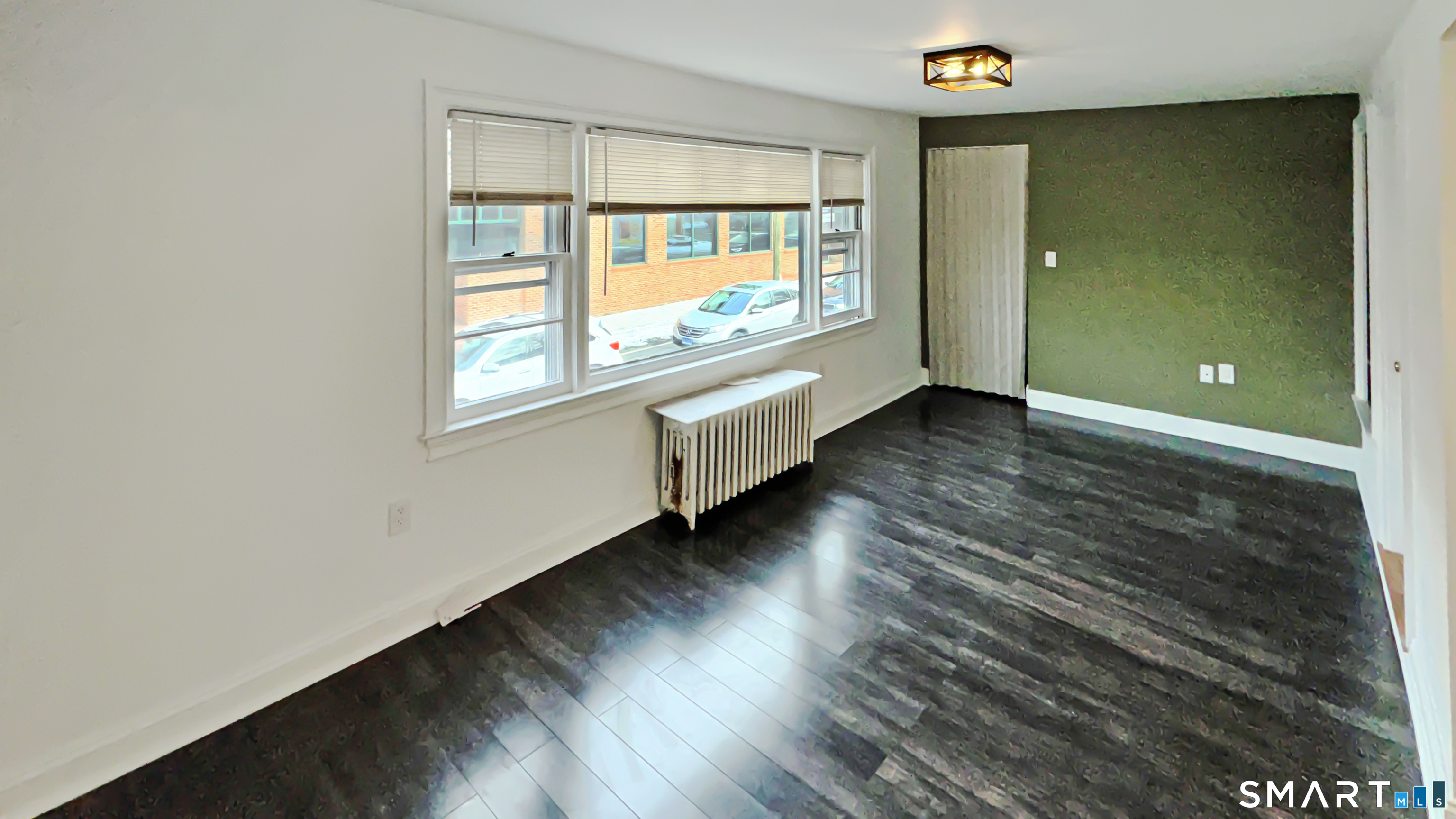 18 Riverside Avenue Westport, CT 06880 - Photo 3 of 6 an empty room with wooden floor and windows