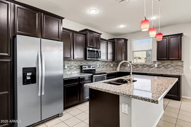 a kitchen with a sink cabinets and stainless steel appliances