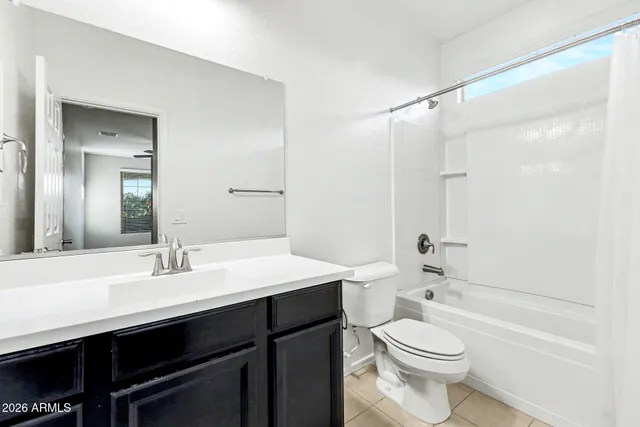 an empty room with closet and a ceiling fan