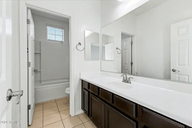 an empty room with a ceiling fan and window