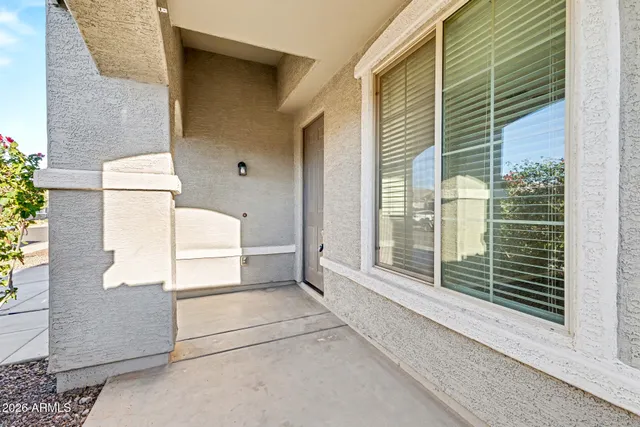 a view of a hallway with wooden floor and entryway
