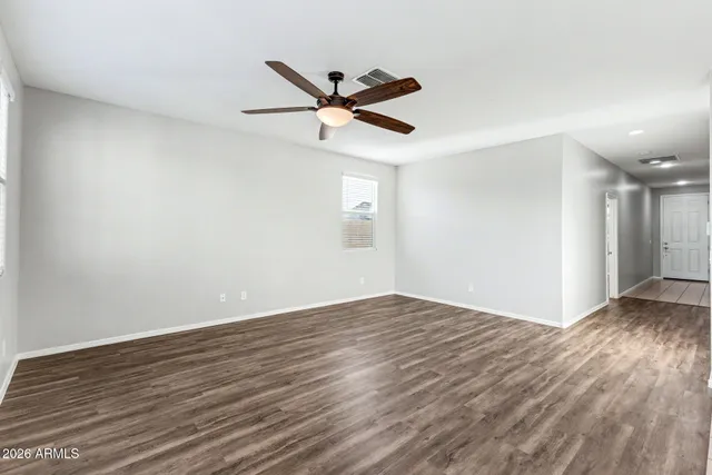 a kitchen with stainless steel appliances kitchen island granite countertop a refrigerator and a sink