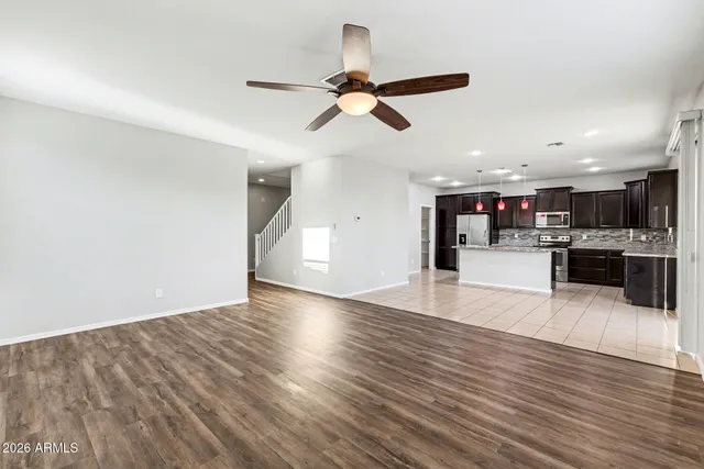 a kitchen with stainless steel appliances kitchen island granite countertop a sink counter top space cabinets and a view of kitchen