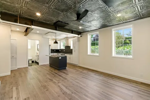 a kitchen with kitchen island a sink stove and wooden floor