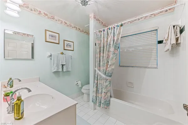 a bathroom with a sink mirror and a shower