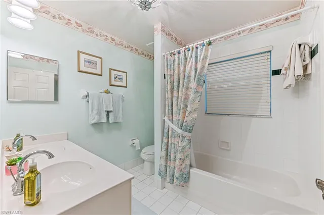 a bathroom with a sink mirror and a shower