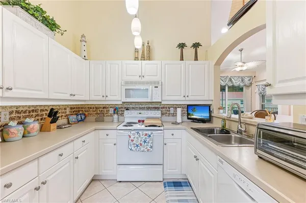 a kitchen with cabinets appliances a sink and a counter top