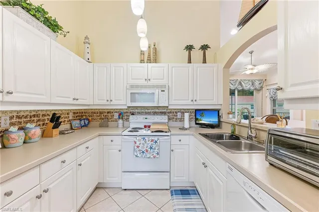 a kitchen with cabinets appliances a sink and a counter top