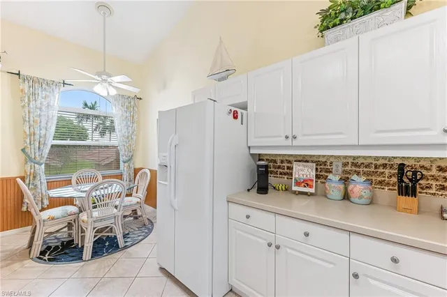 a kitchen with cabinets and window