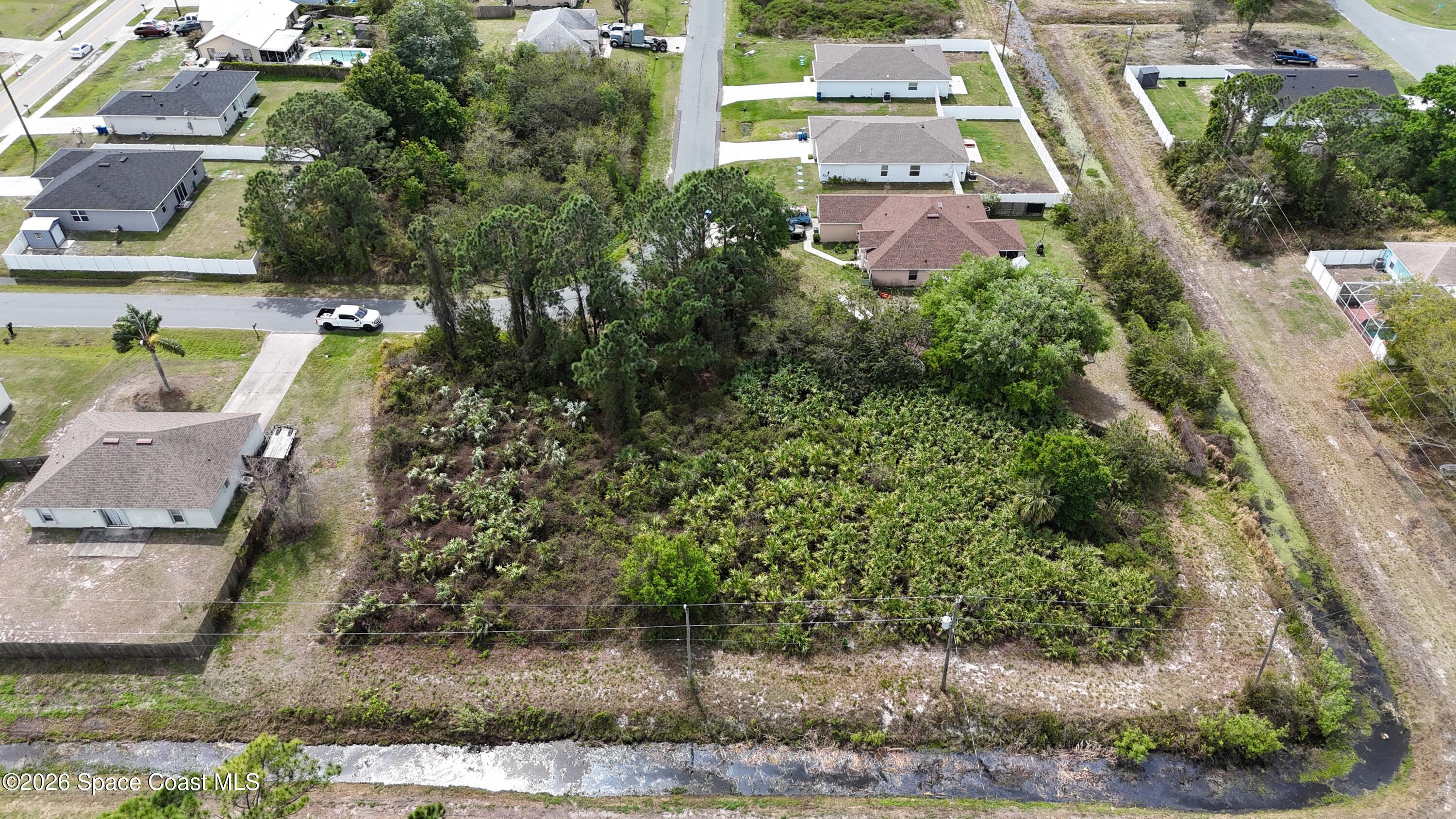1805 Raintree Avenue Southeast Palm Bay, FL 32909 - Photo 13 of 14 an aerial view of residential houses with outdoor space and parking