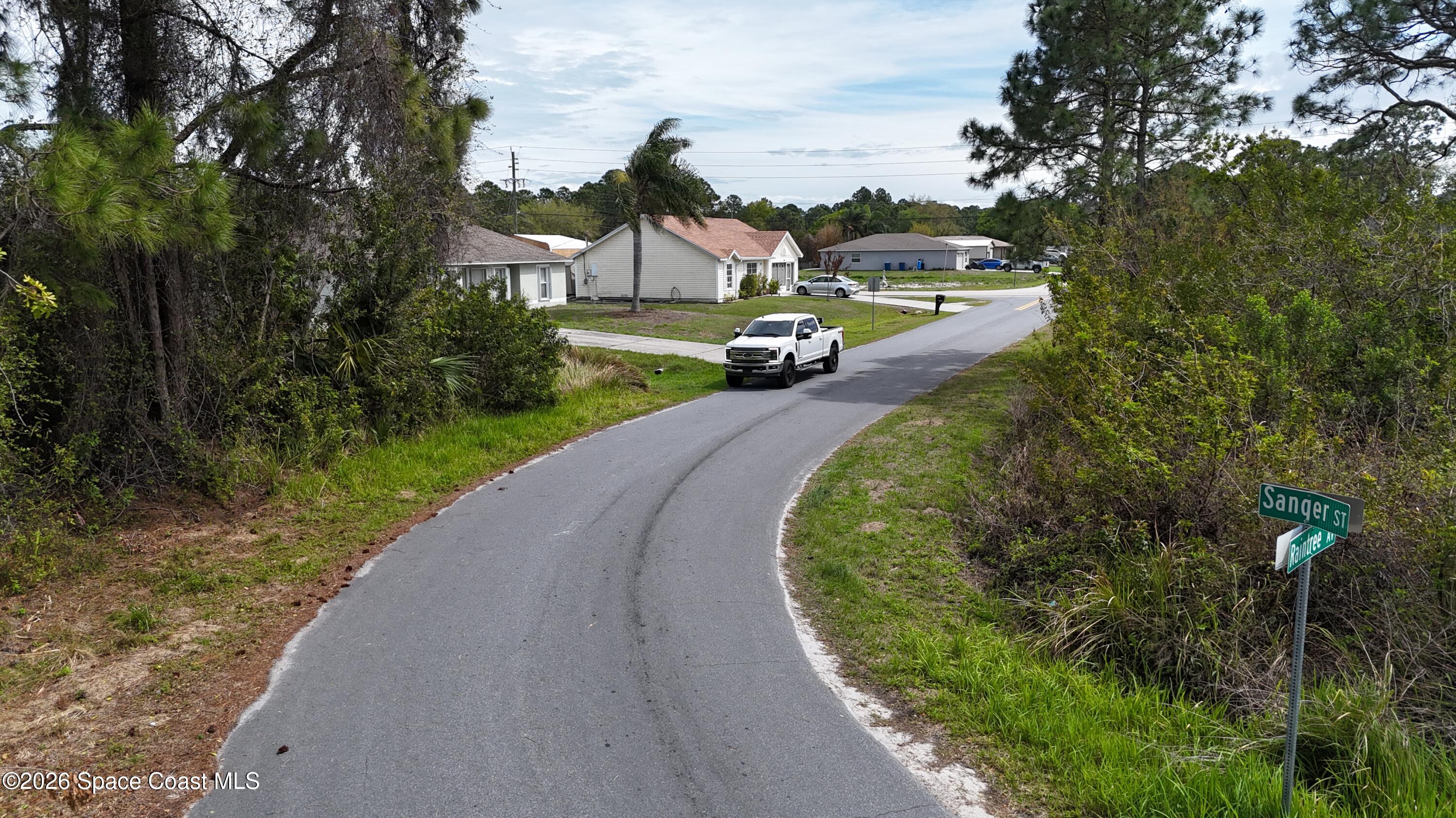 1805 Raintree Avenue Southeast Palm Bay, FL 32909 - Photo 14 of 14 a view of a house with a yard and lake view