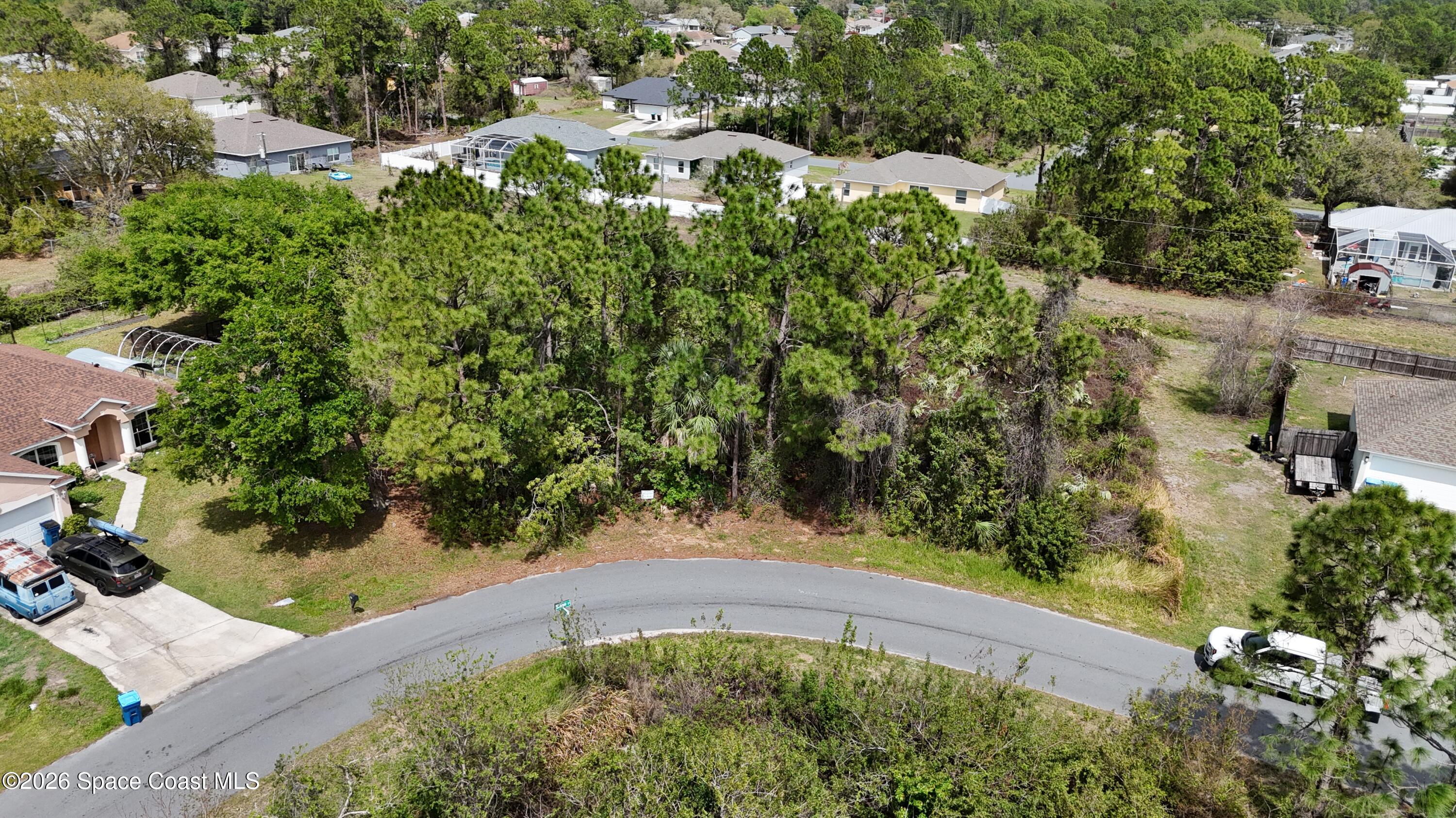 1805 Raintree Avenue Southeast Palm Bay, FL 32909 - Photo 2 of 14 an aerial view of a house with a yard