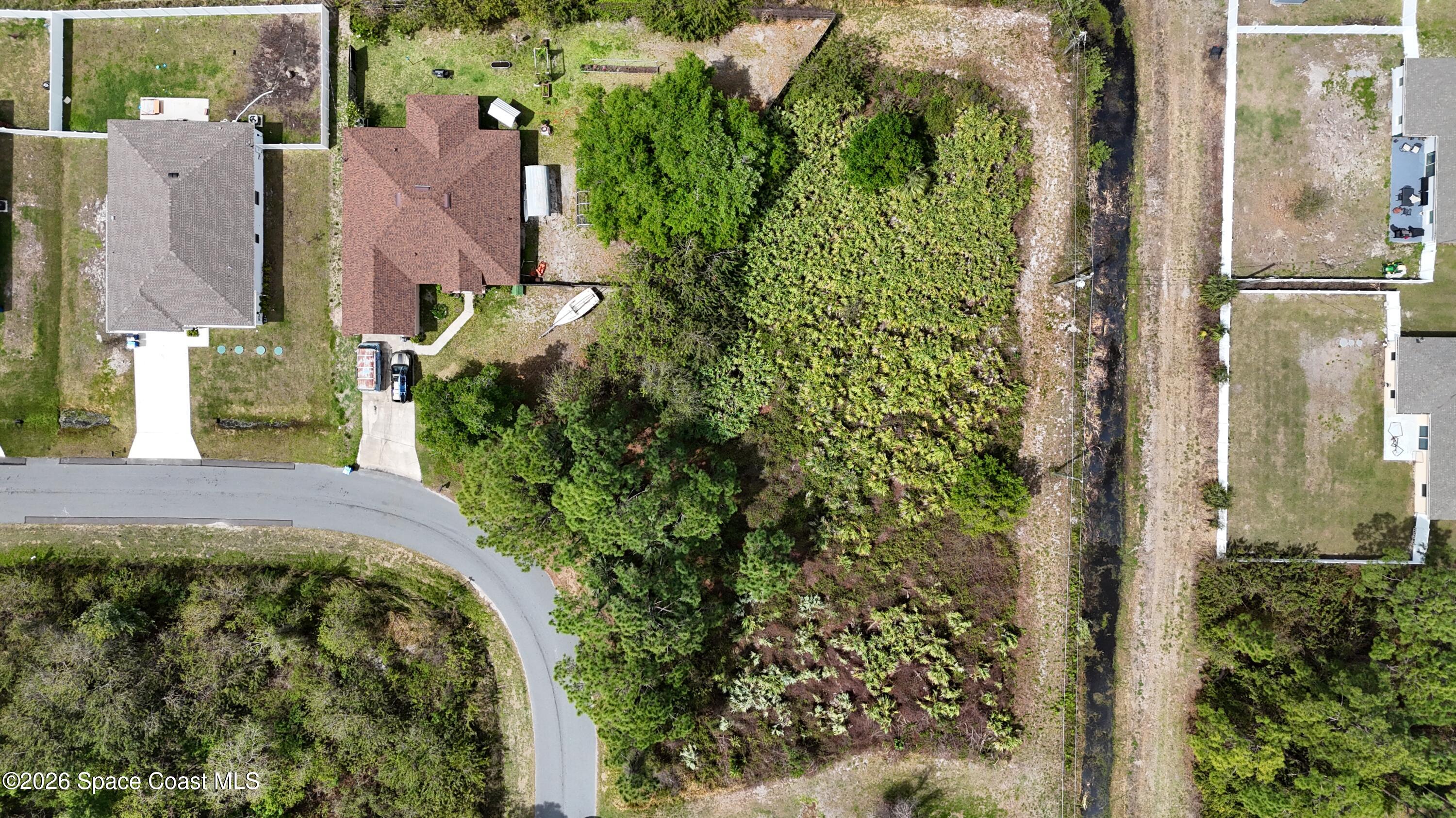 1805 Raintree Avenue Southeast Palm Bay, FL 32909 - Photo 6 of 14 an aerial view of a house with a yard