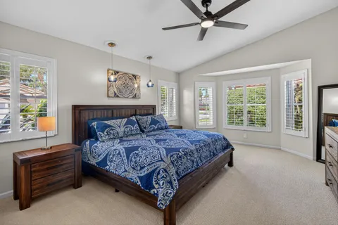 a bedroom with a large bed and a window