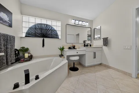 a bathroom with a sink a mirror and a bathtub