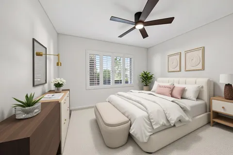 a bedroom with a bed and a potted plant