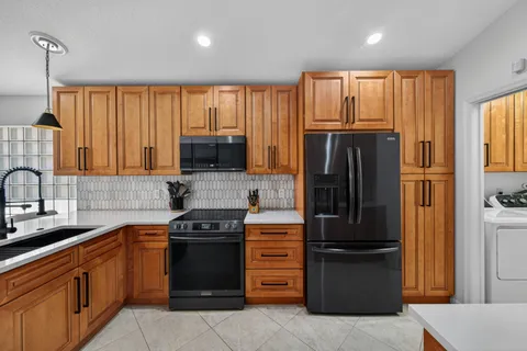 a kitchen with a refrigerator stove and sink