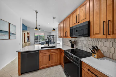 a kitchen with a sink a stove and cabinets