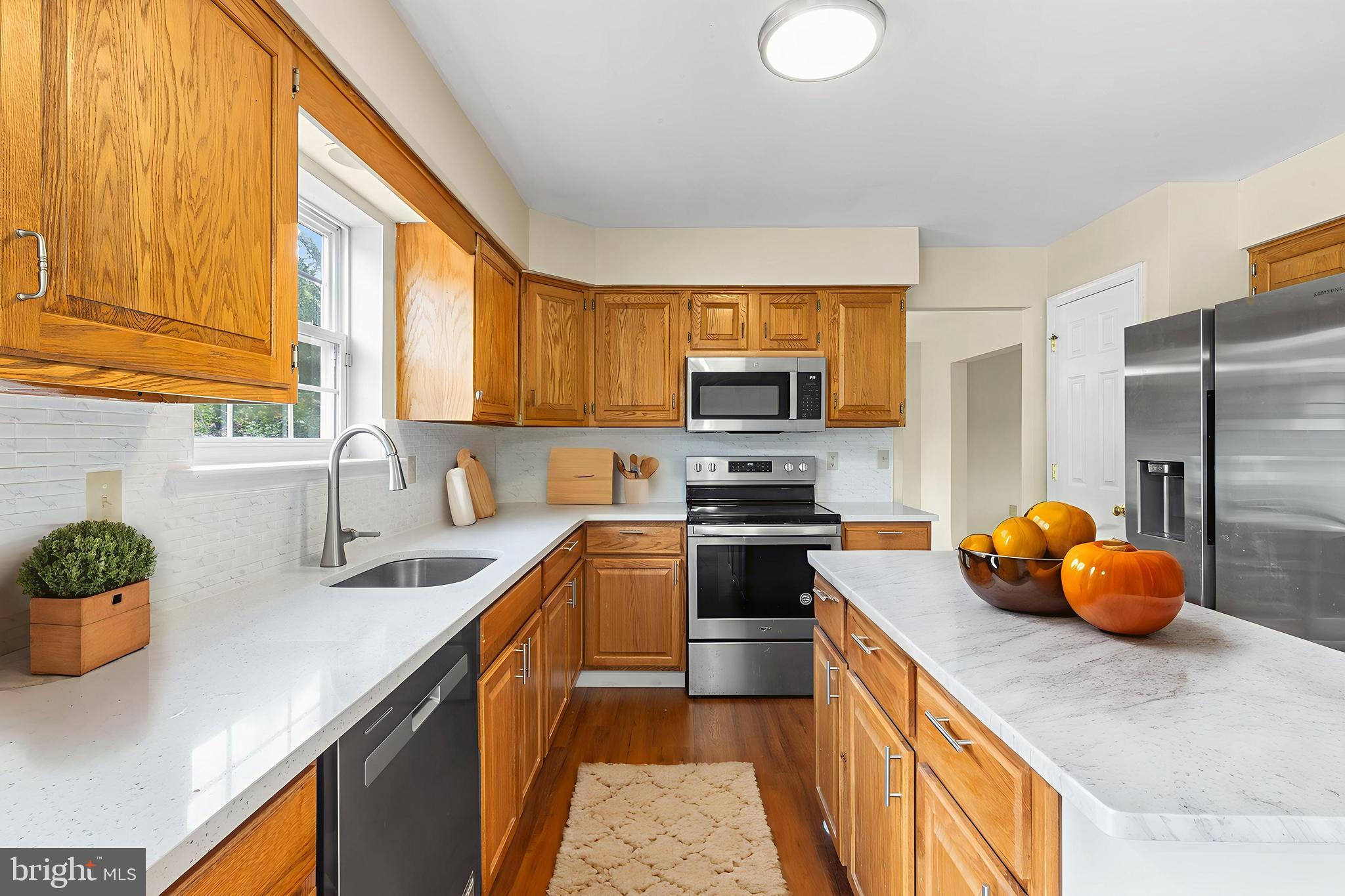 2004 Drake Run Royersford, PA 19468 - Photo 12 of 38 a kitchen with stainless steel appliances a sink a stove a refrigerator cabinets and a window
