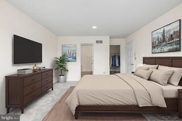 a spacious bedroom with a large bed and a flat screen tv