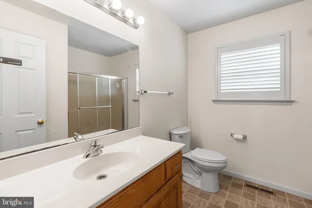 a bathroom with a glass shower door