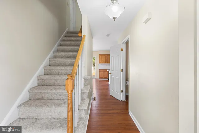 a view of a hallway with wooden floor and entryway