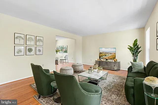 a living room with furniture a couch and a potted plant