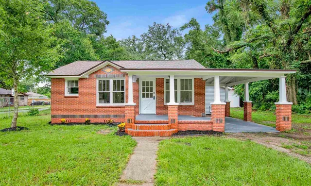 a front view of a house with a yard table and chairs