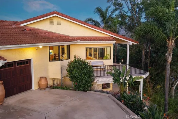 a aerial view of a house with a yard and potted plants