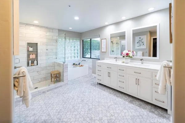 a bathroom with a double vanity sink mirror and toilet