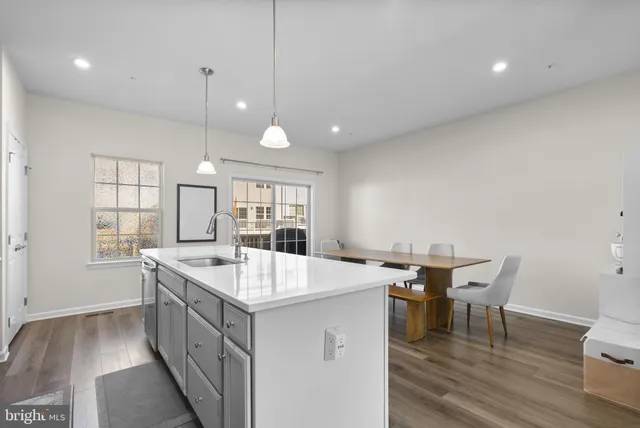 a large kitchen with a table and chairs