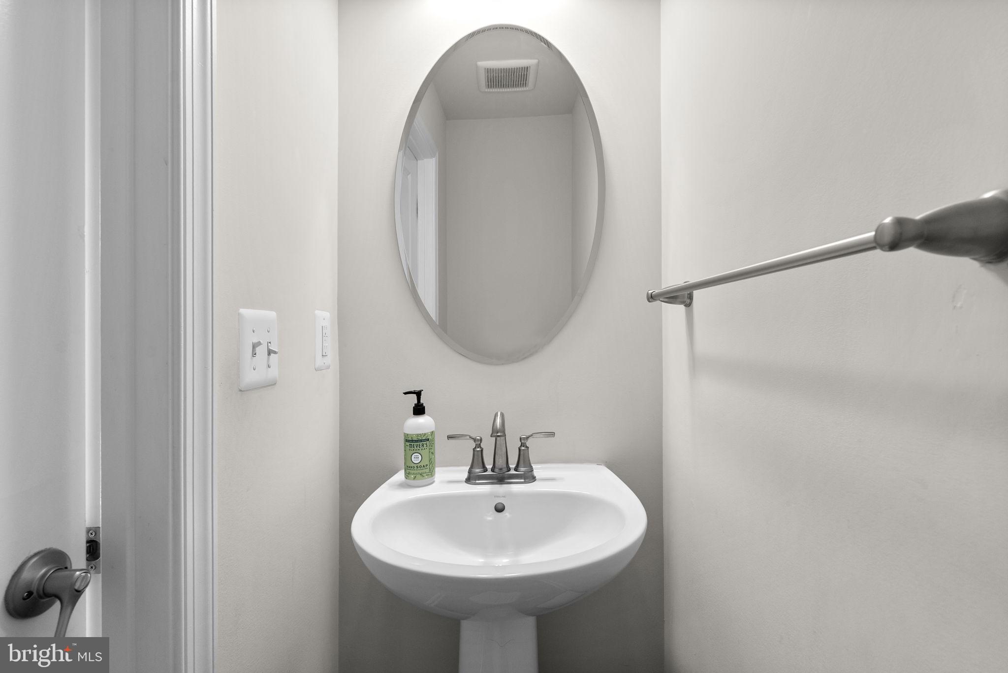 7911 Mine Run Road Hanover, MD 21076 - Photo 17 of 49 a bathroom with a sink and a mirror