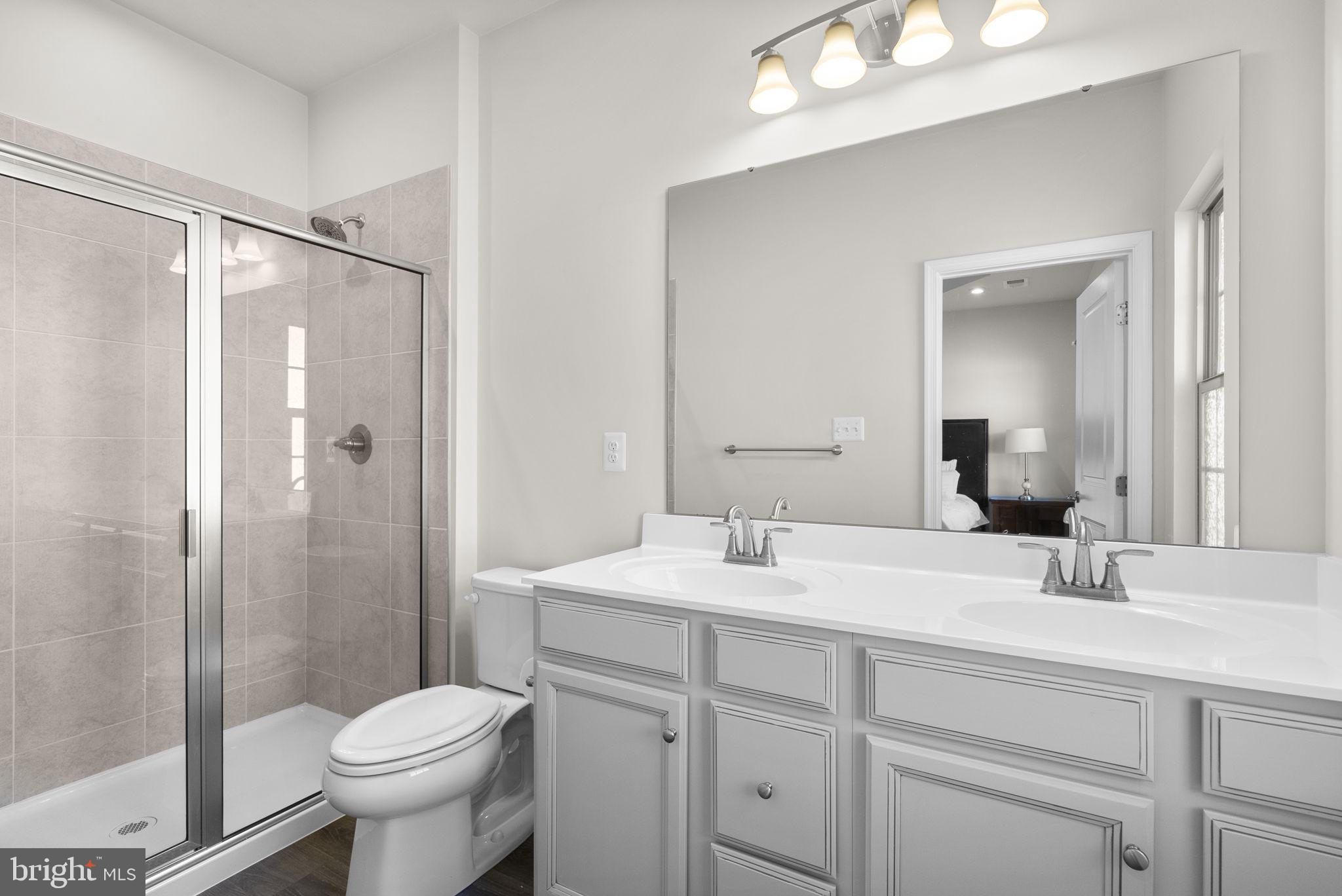 7911 Mine Run Road Hanover, MD 21076 - Photo 21 of 49 a bathroom with a sink toilet and shower