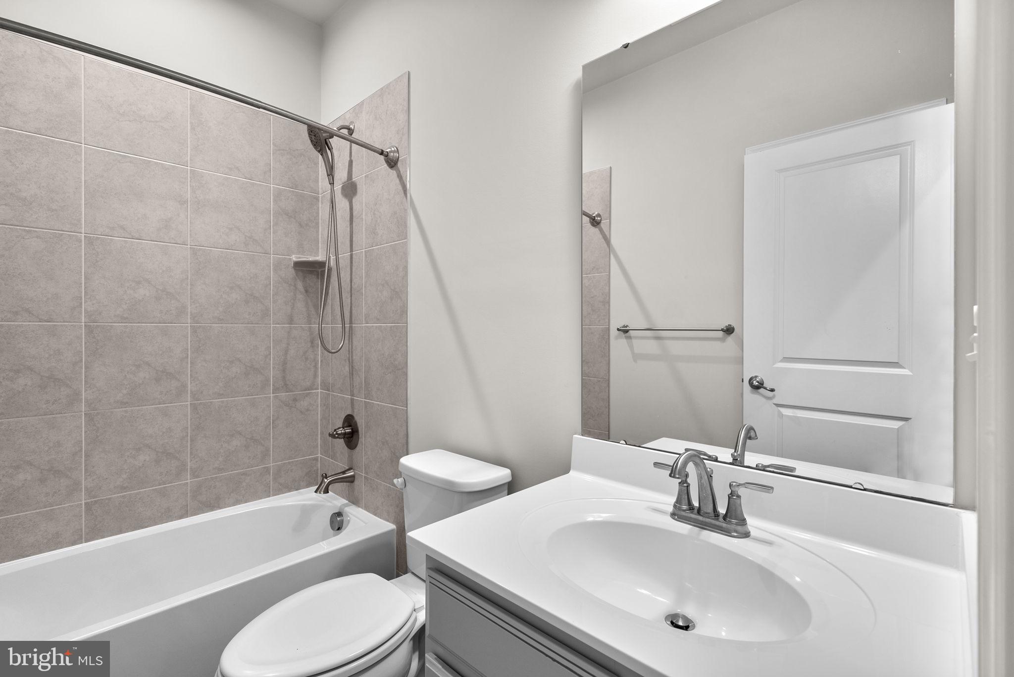 7911 Mine Run Road Hanover, MD 21076 - Photo 29 of 49 a bathroom with a sink toilet and shower