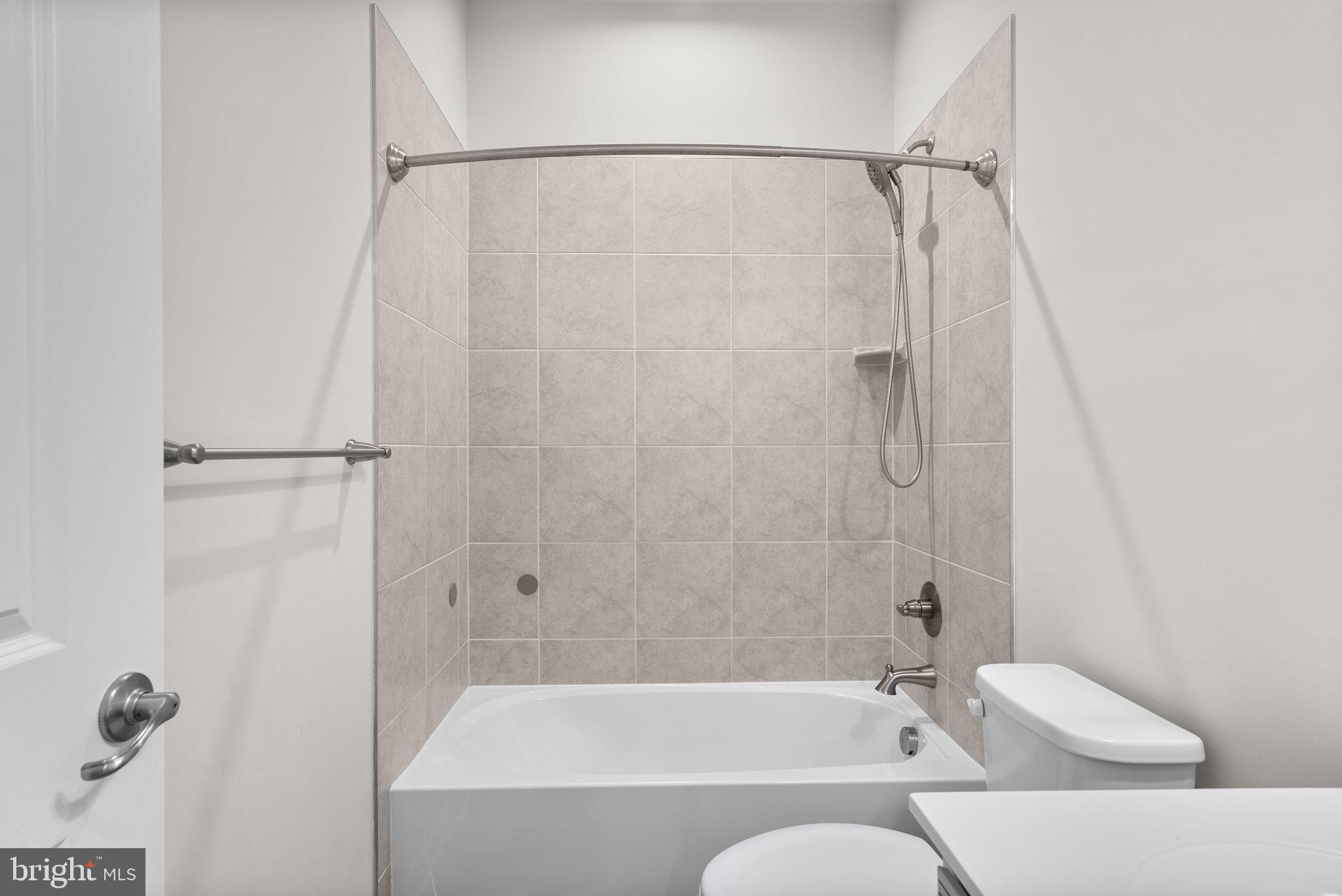 7911 Mine Run Road Hanover, MD 21076 - Photo 30 of 49 a bathroom with a bathtub and a shower