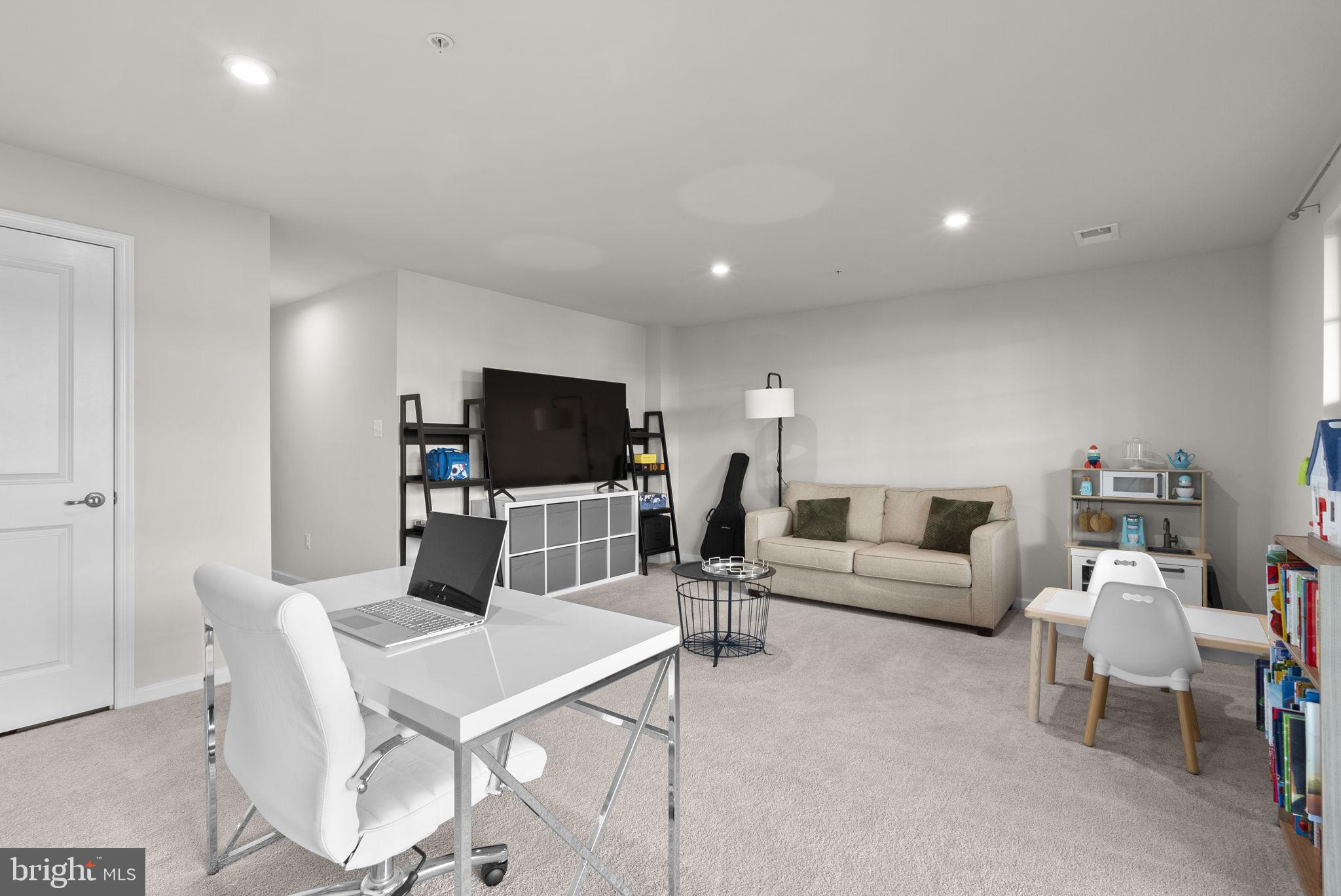 7911 Mine Run Road Hanover, MD 21076 - Photo 32 of 49 a living room with furniture and a flat screen tv