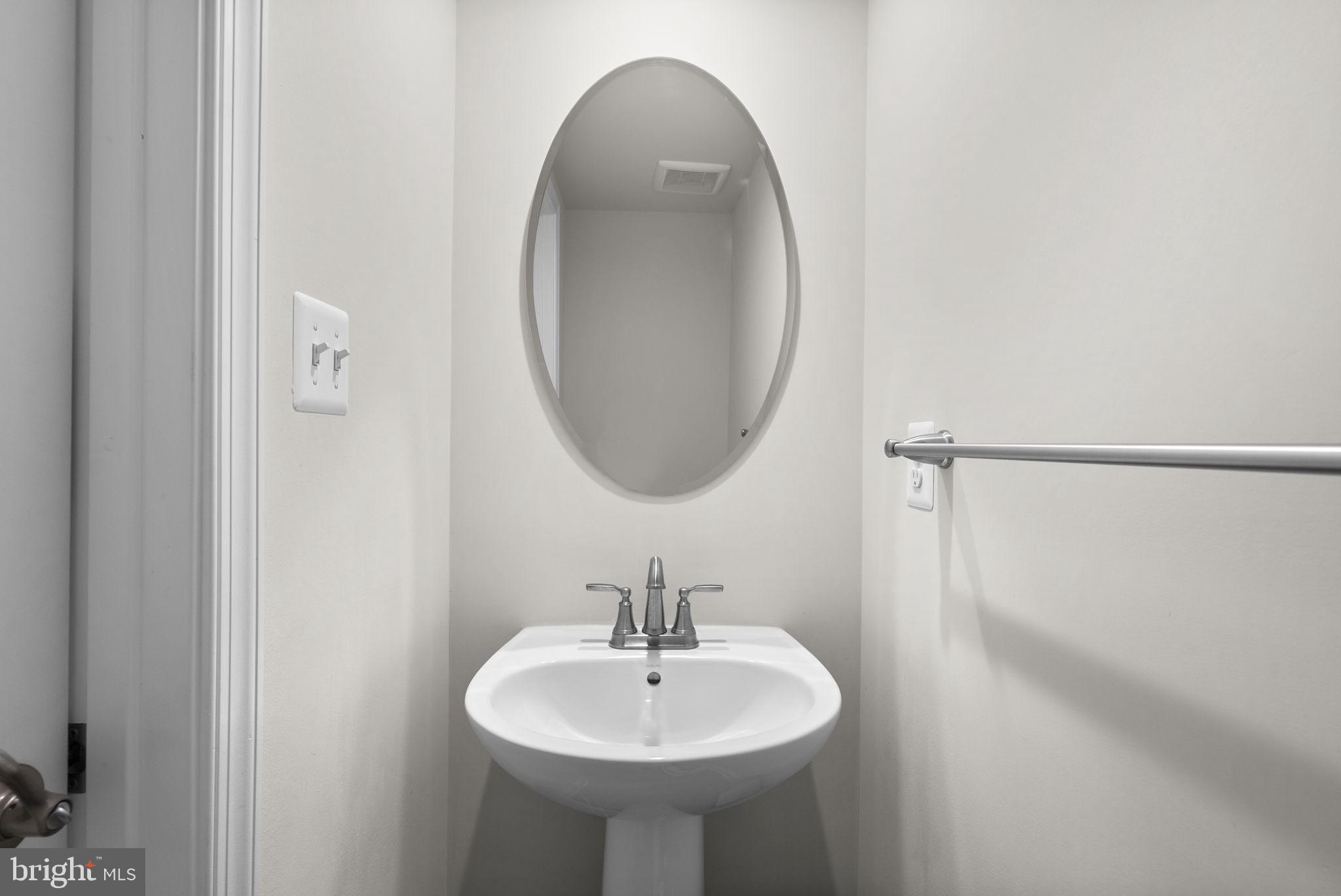 7911 Mine Run Road Hanover, MD 21076 - Photo 34 of 49 a bathroom with a sink and a mirror