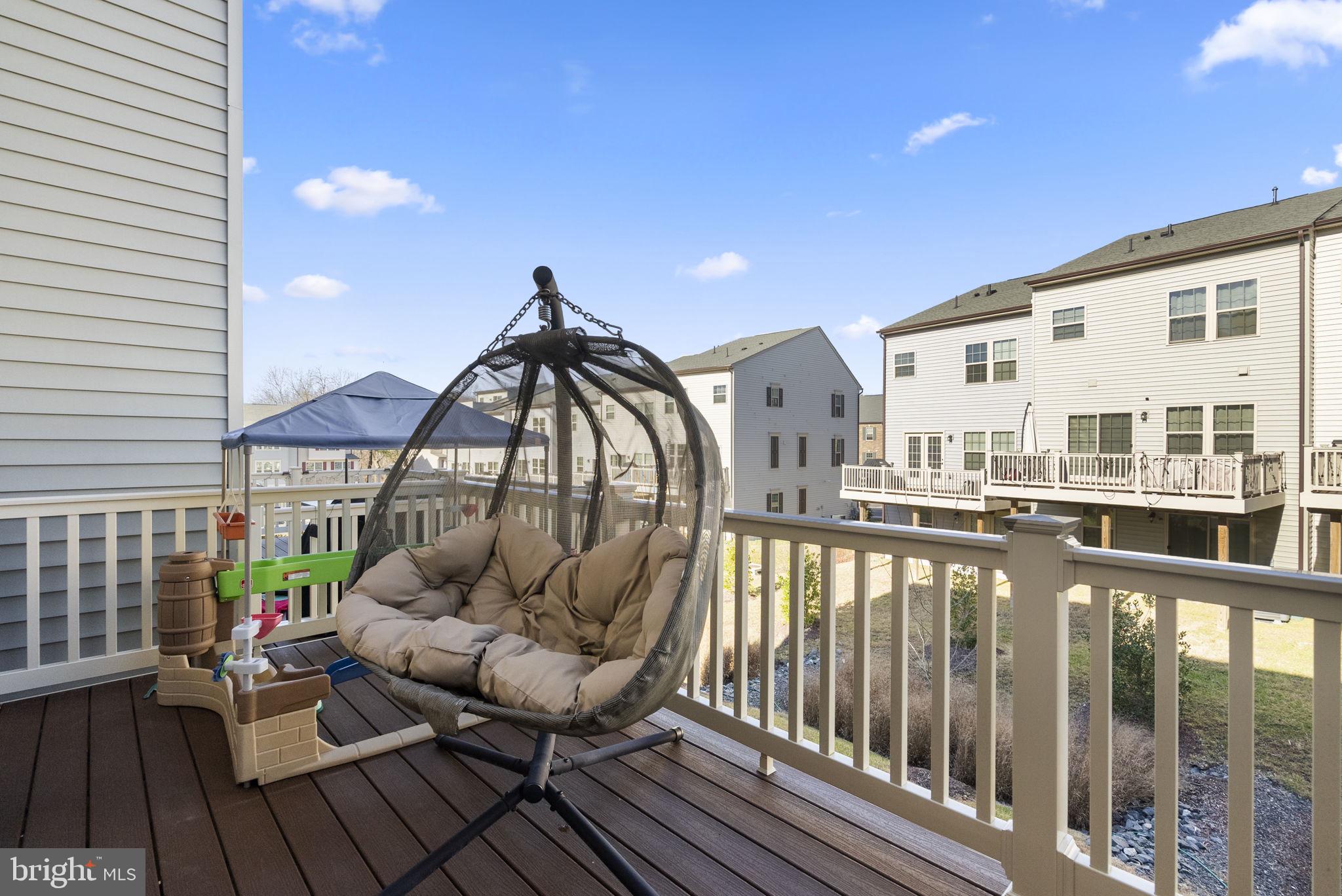 7911 Mine Run Road Hanover, MD 21076 - Photo 35 of 49 a balcony with wooden floor table and chairs