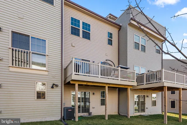 a front view of a residential apartment building with a yard
