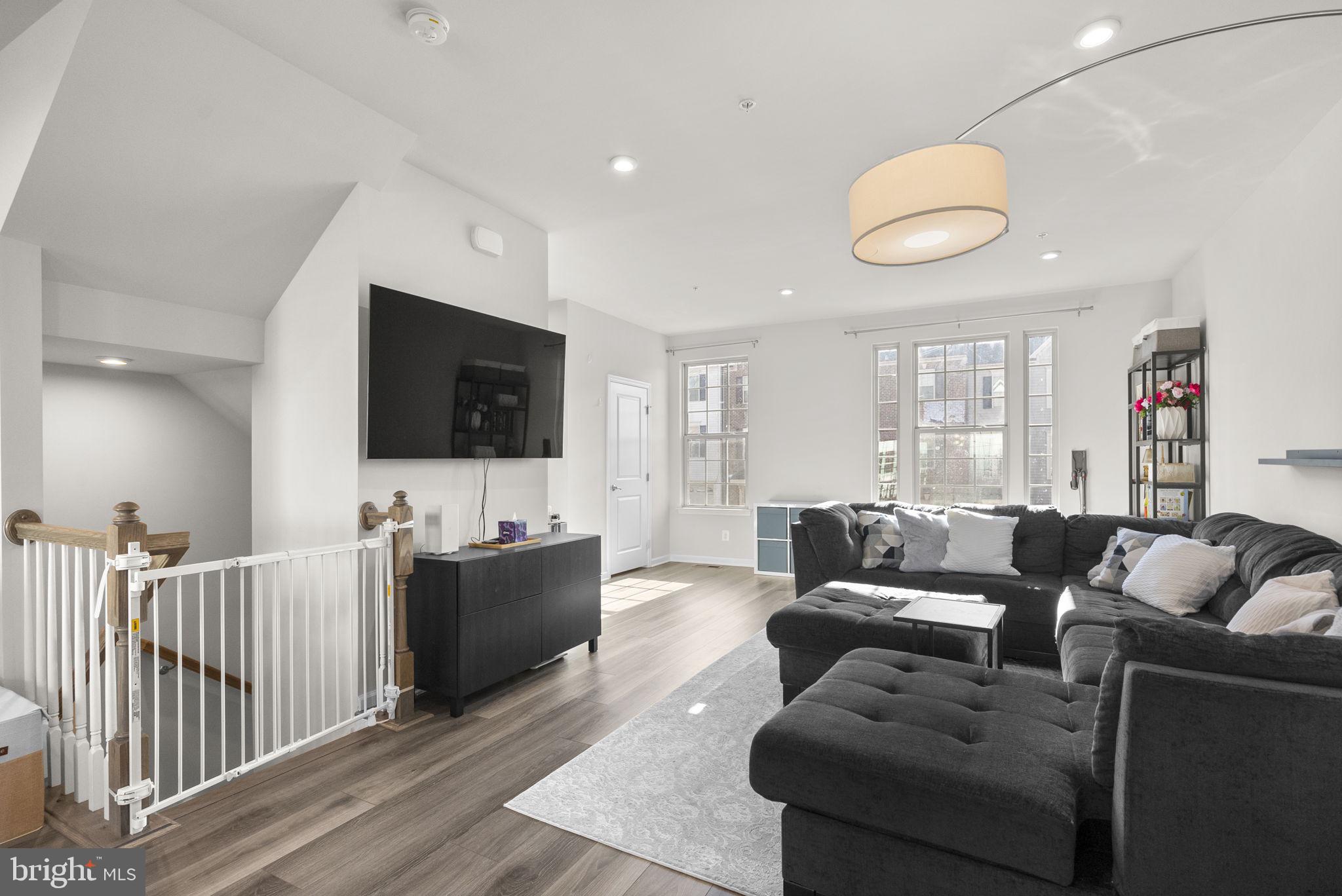 7911 Mine Run Road Hanover, MD 21076 - Photo 7 of 49 a living room with furniture and a flat screen tv