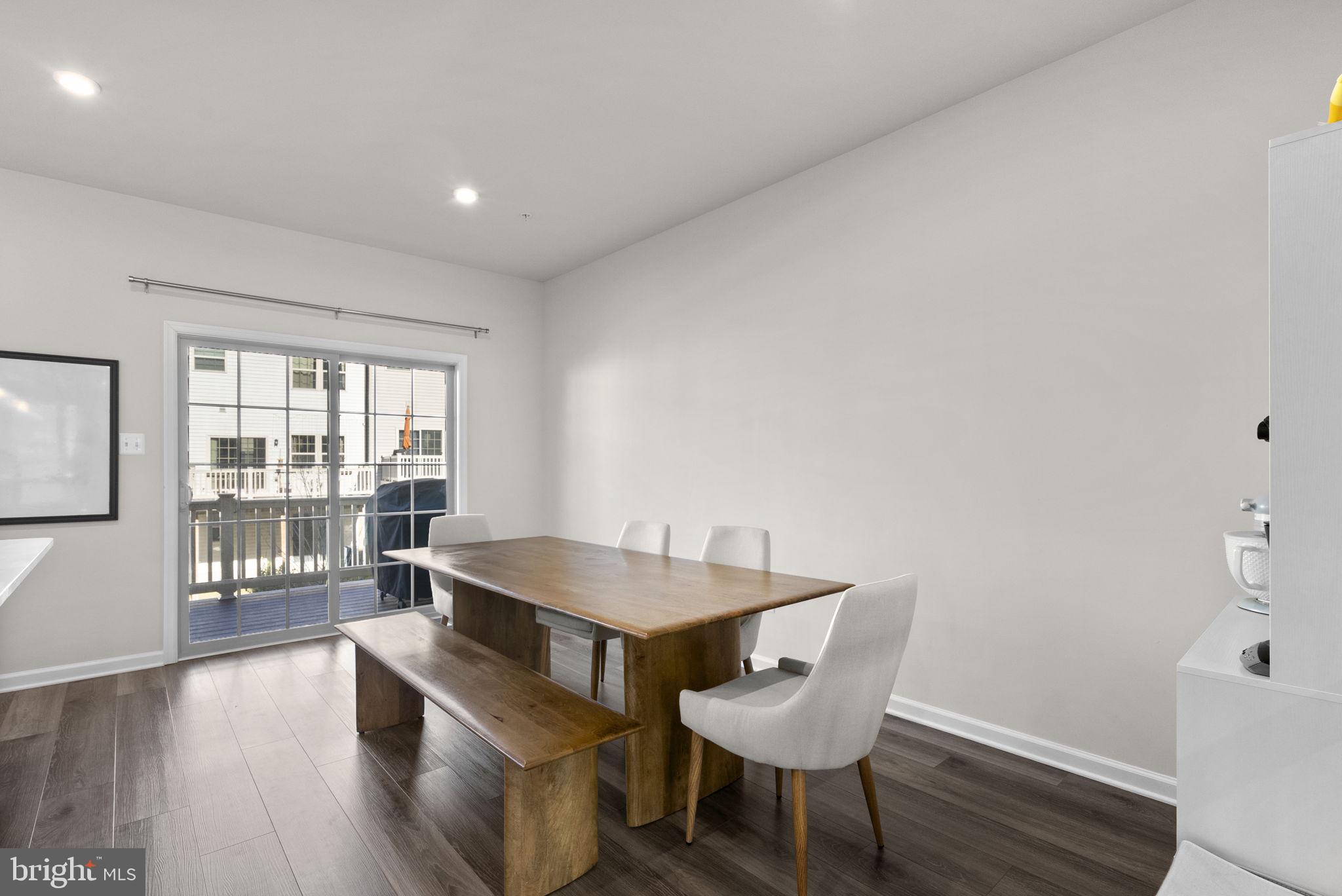 7911 Mine Run Road Hanover, MD 21076 - Photo 10 of 49 a dining room with furniture and wooden floor