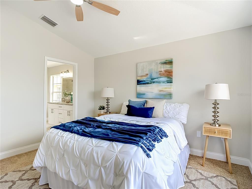 5310 Anhinga Trail New Port Richey, FL 34653 - Photo 15 of 27 a bedroom with a bed and a lamp