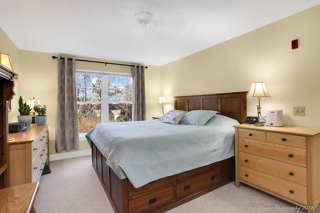 135 Beach Road, Unit 308 Salisbury, MA 01952 - Photo 8 of 15 a bedroom with a large bed and a large window