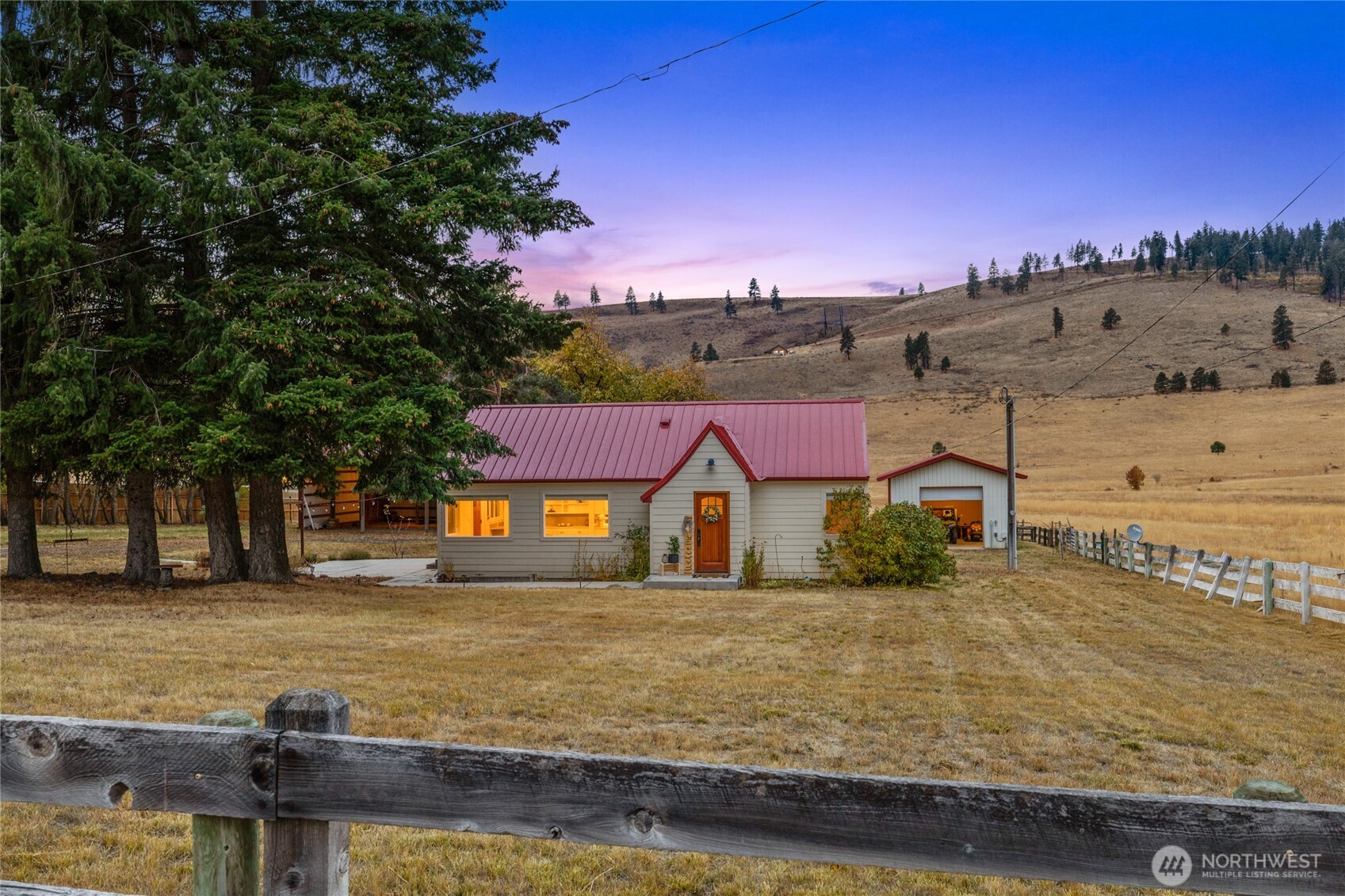 1371 Bettas Road Cle Elum, WA 98922 - Photo 4 of 40 a view of a town with large trees and a barn