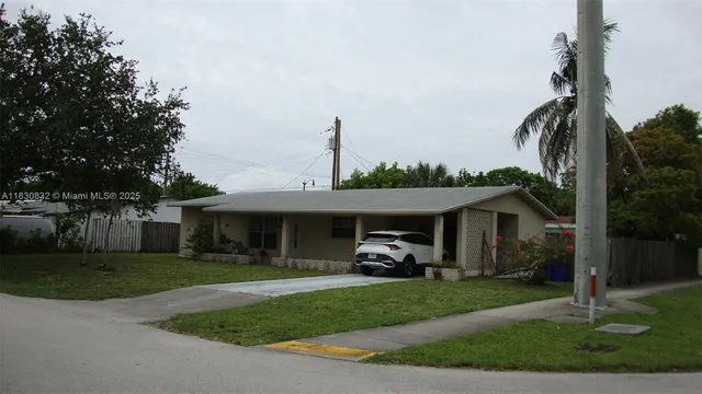 a front view of a house with a garden and patio