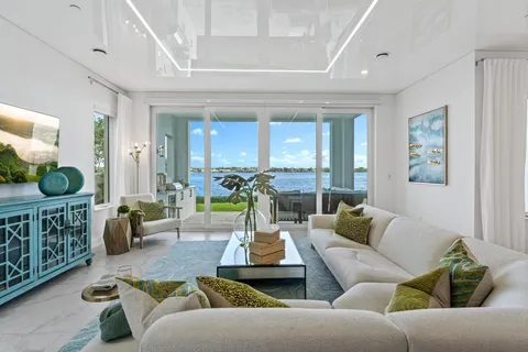 a living room with furniture and large windows